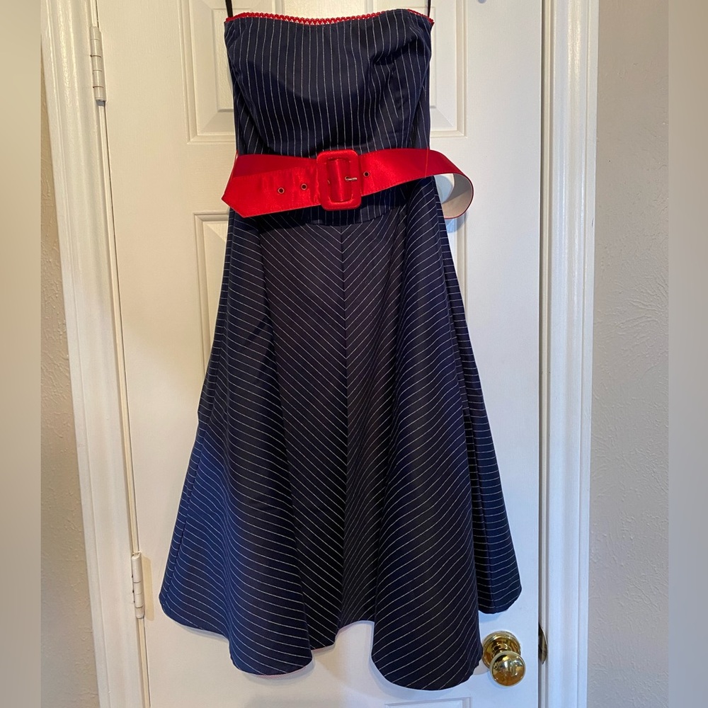 Navy blue pinstriped strapless dress with red trim and belt